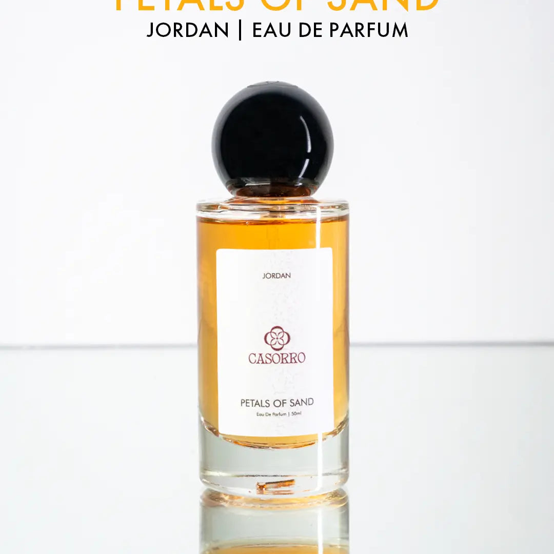 Perfume bottle labeled 'Petals of Sand' by CASORRO on a white background