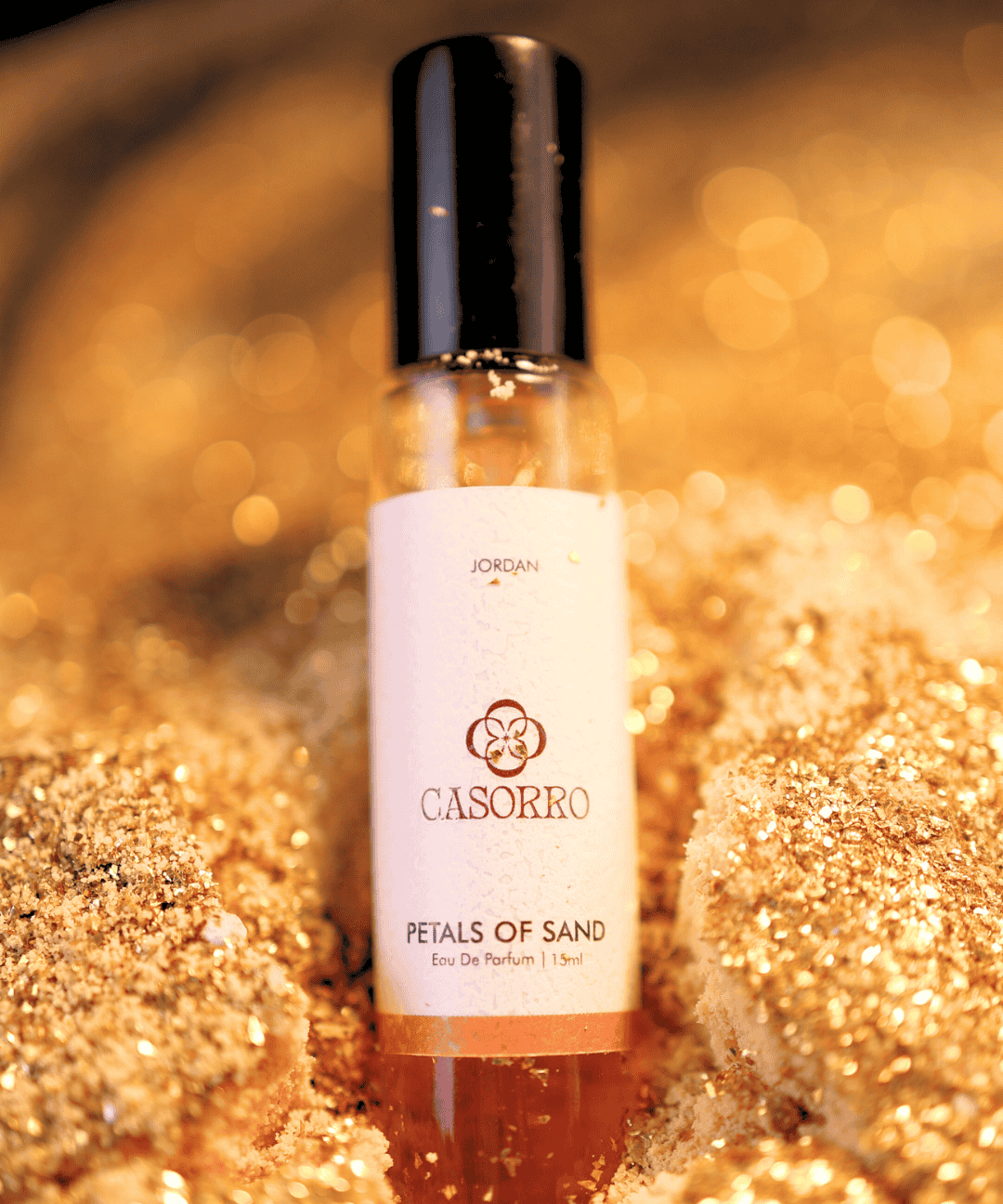 Perfume bottle labeled 'Casorro' on a glittery gold background