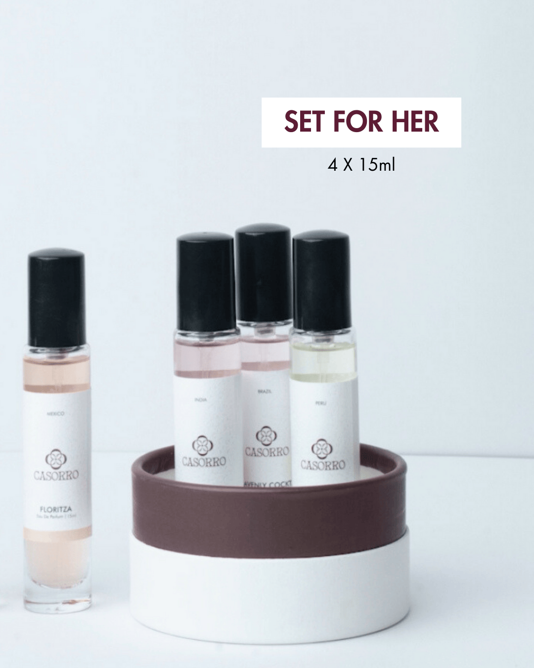 Set of four 15ml bottles with a decorative stand on a light gray background